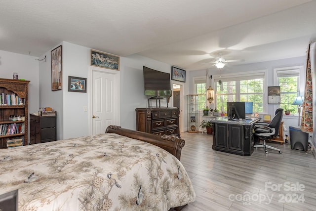 bedroom with ceiling fan and light hardwood / wood-style floors