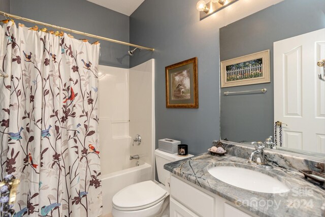 full bathroom featuring shower / tub combo with curtain, vanity, and toilet