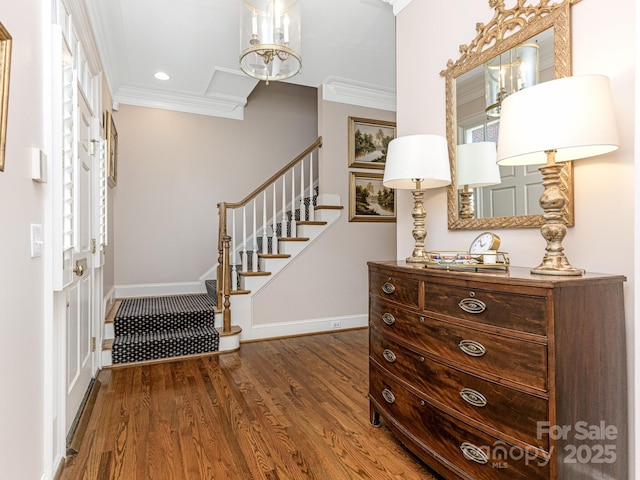 foyer with dark hardwood / wood-style flooring, plenty of natural light, and crown molding