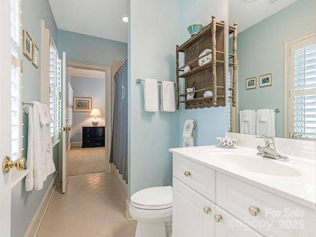 bathroom featuring tile patterned floors, vanity, and toilet