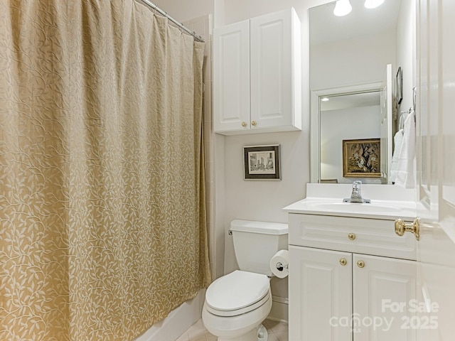 bathroom with toilet, tile patterned floors, and vanity