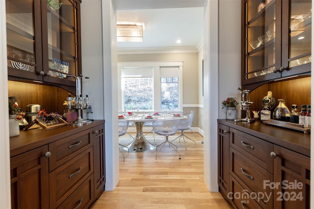 interior space featuring ornamental molding and light hardwood / wood-style flooring