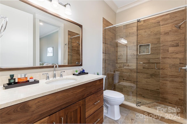 bathroom with tile flooring, crown molding, a shower with door, toilet, and vanity