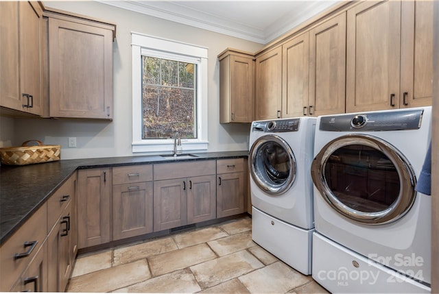 washroom featuring cabinets, crown molding, washing machine and clothes dryer, sink, and light tile floors