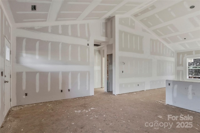 unfurnished living room with lofted ceiling