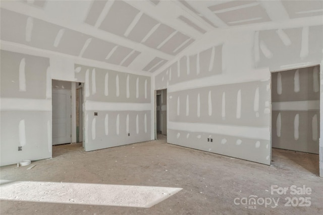 empty room with lofted ceiling