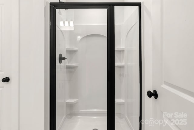 bathroom with a shower with shower door