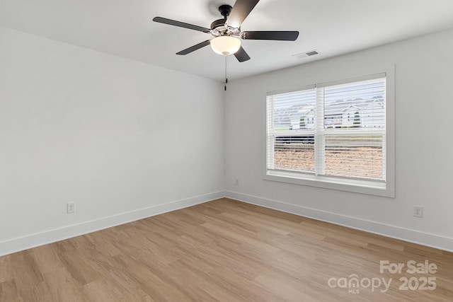 empty room featuring ceiling fan and light wood-type flooring