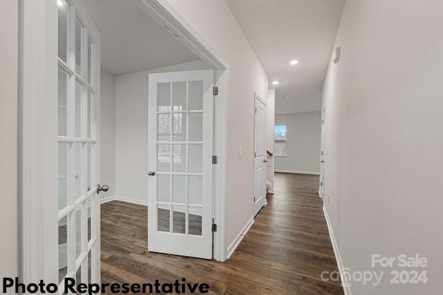 corridor featuring french doors and dark wood-type flooring