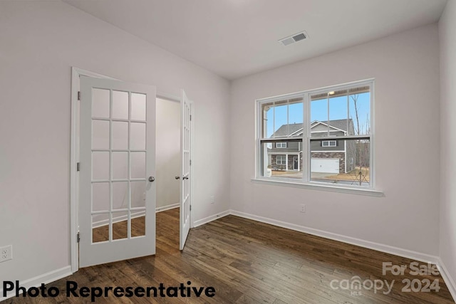 unfurnished room featuring dark wood-type flooring