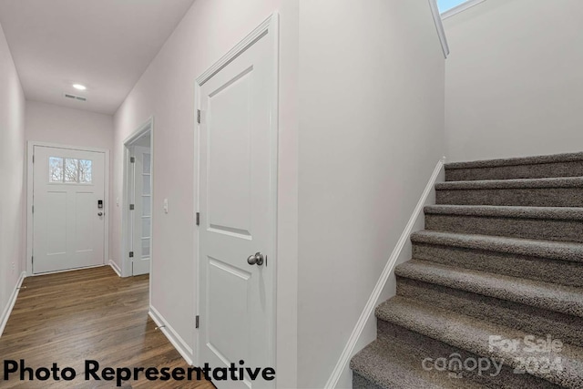 stairs featuring hardwood / wood-style flooring