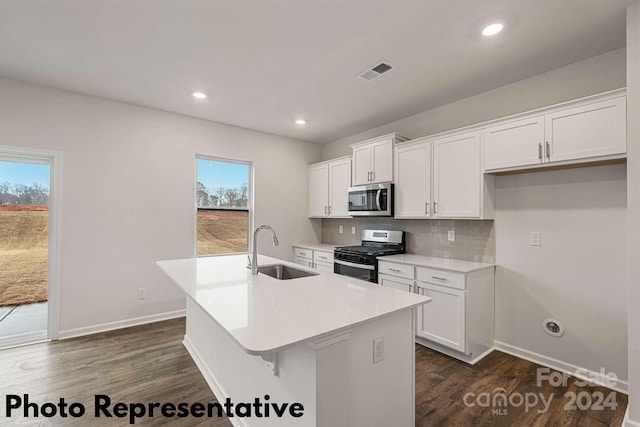 kitchen featuring stainless steel appliances, sink, dark hardwood / wood-style flooring, and white cabinetry