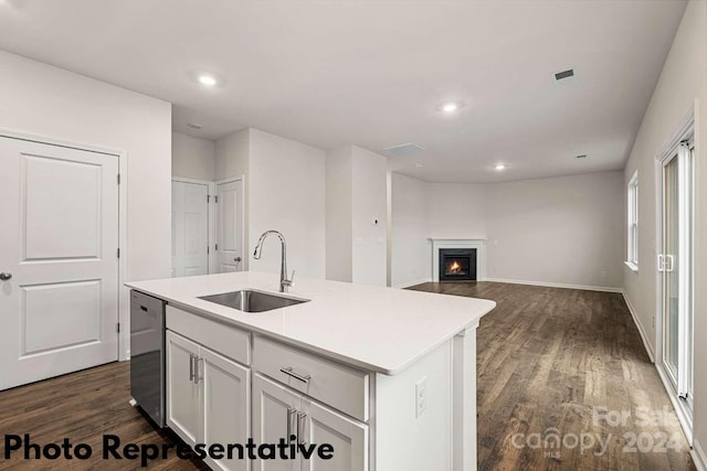 kitchen with dark hardwood / wood-style flooring, white cabinets, a kitchen island with sink, sink, and dishwasher