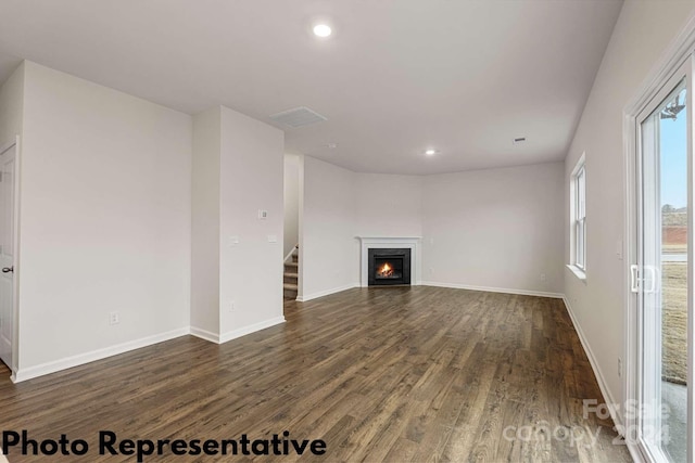 unfurnished living room with dark hardwood / wood-style flooring