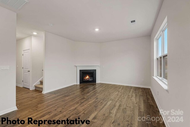 unfurnished living room featuring hardwood / wood-style flooring