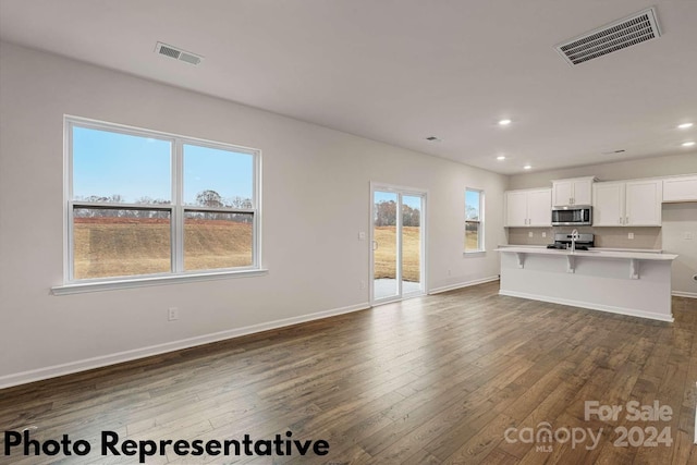 unfurnished living room with hardwood / wood-style flooring