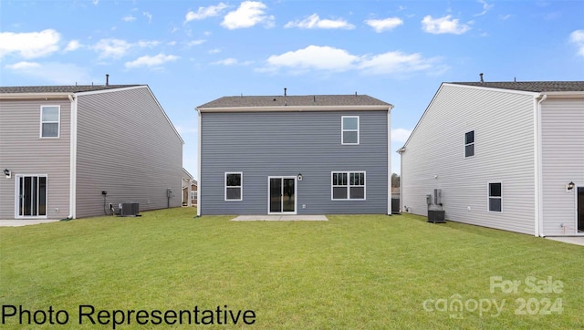 back of house with central AC, a patio area, and a lawn