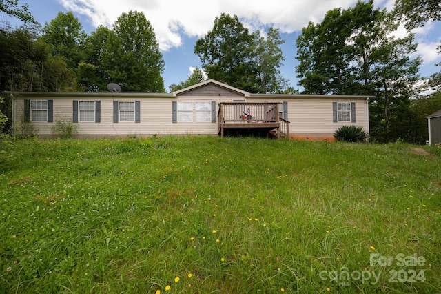 view of front of home with a deck and a front yard