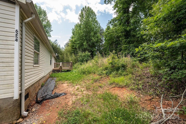 view of yard with a wooden deck