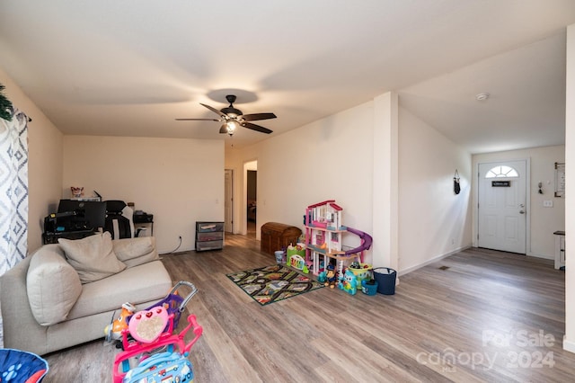 living room with ceiling fan and hardwood / wood-style floors