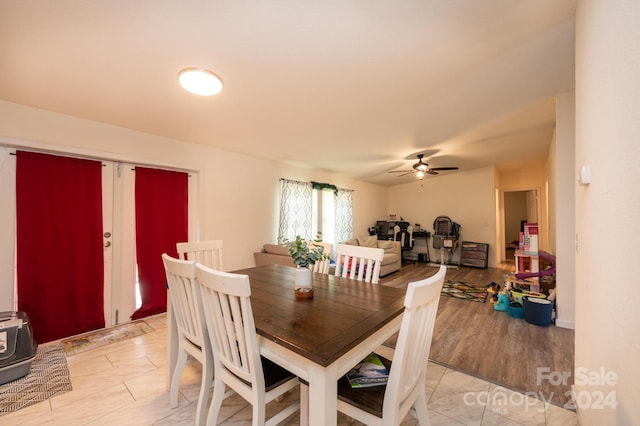 dining room with ceiling fan and a wood stove