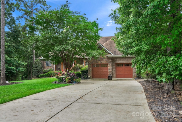 view of front of house with a garage and a front yard