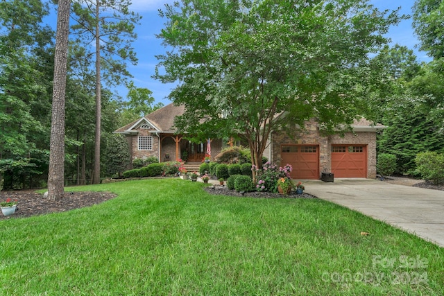 view of front of home with a garage and a front yard