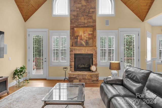 living room with high vaulted ceiling, a fireplace, hardwood / wood-style flooring, and wood ceiling