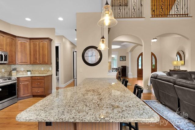 kitchen with backsplash, a center island, and stainless steel appliances