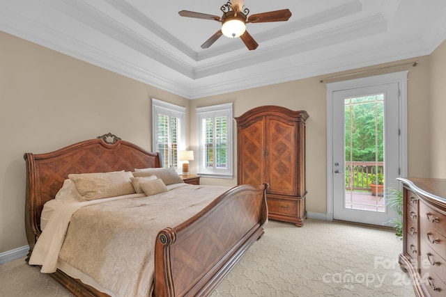 bedroom with ceiling fan, a tray ceiling, crown molding, light carpet, and access to exterior