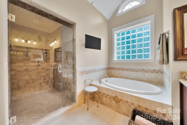 bathroom featuring a healthy amount of sunlight, lofted ceiling, and plus walk in shower