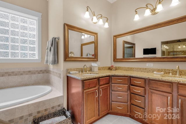 bathroom with tile floors, a relaxing tiled bath, and dual vanity