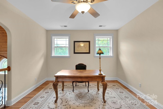 office area with ceiling fan, hardwood / wood-style flooring, and a wealth of natural light