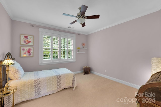 bedroom featuring carpet, ornamental molding, and ceiling fan