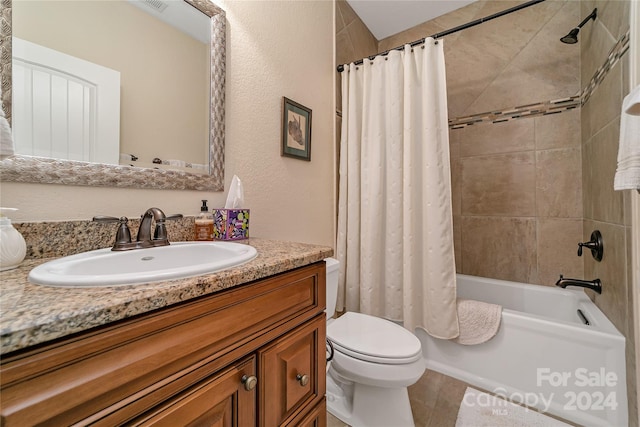 full bathroom with tile floors, shower / bath combo, vanity, and toilet