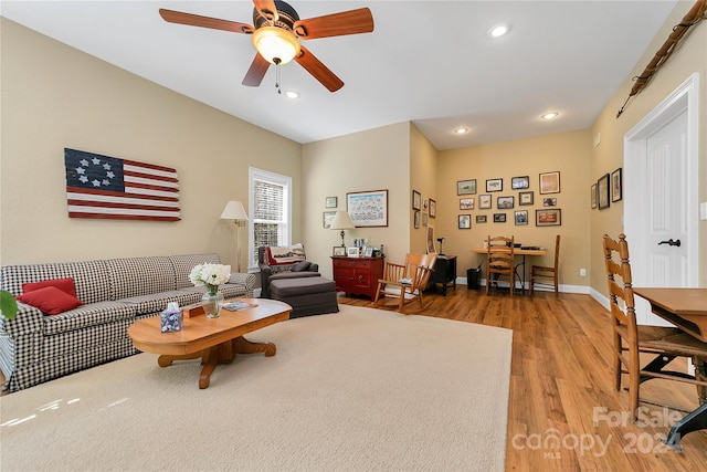 living room with wood-type flooring and ceiling fan