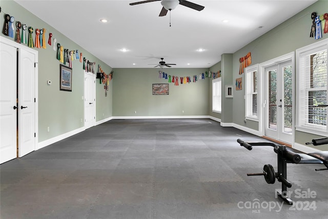 workout room with ceiling fan and french doors