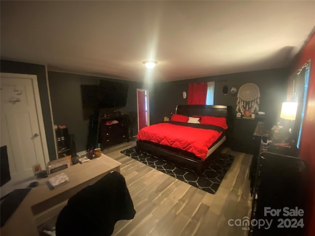 bedroom with hardwood / wood-style floors