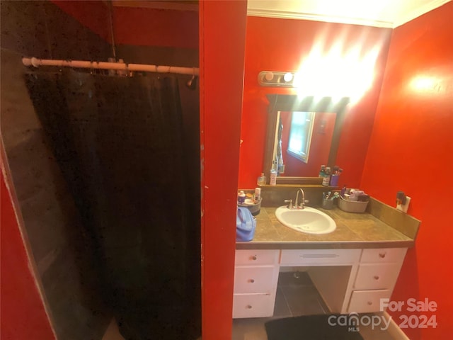 bathroom with ornamental molding and vanity