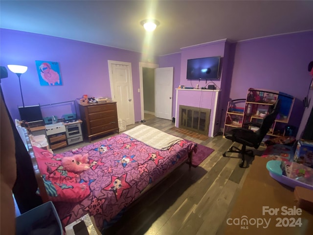 bedroom with hardwood / wood-style flooring