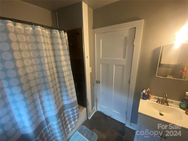 bathroom featuring tile flooring and vanity