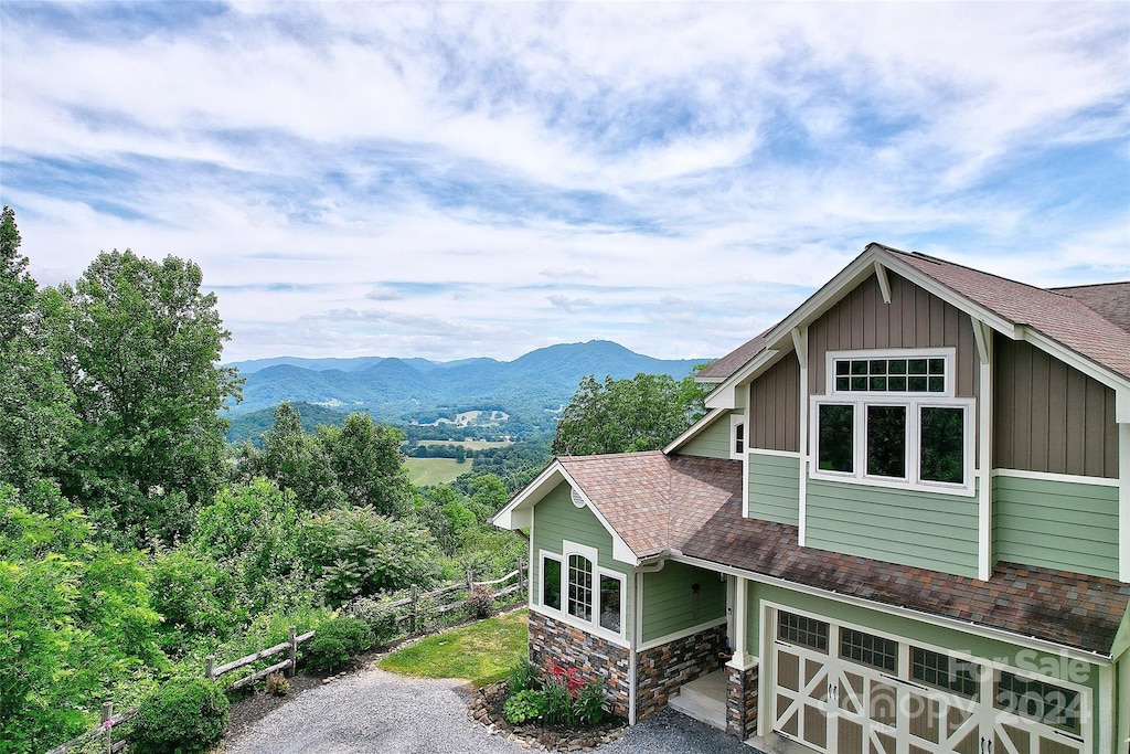 view of property exterior featuring a mountain view and a garage