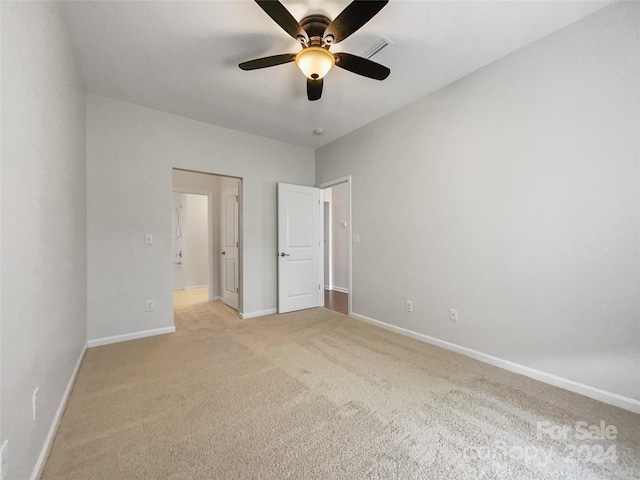 unfurnished bedroom with ceiling fan and light carpet