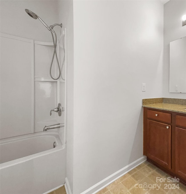 bathroom with bathing tub / shower combination, tile flooring, and vanity