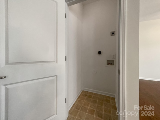 clothes washing area with electric dryer hookup, dark tile flooring, and washer hookup