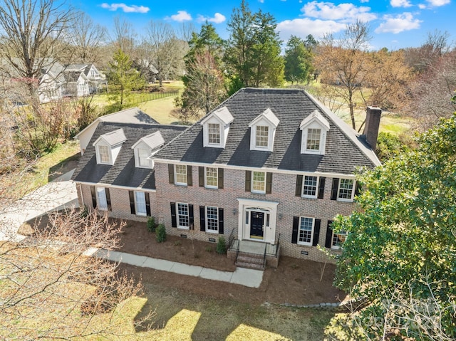 view of front of home featuring crawl space, a chimney, and brick siding