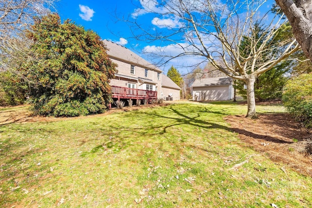 view of yard featuring an outdoor structure and a wooden deck