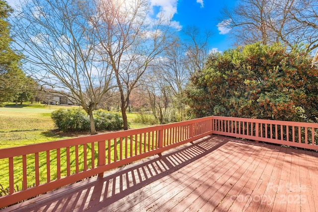 wooden deck with a lawn