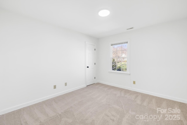 carpeted empty room featuring visible vents and baseboards