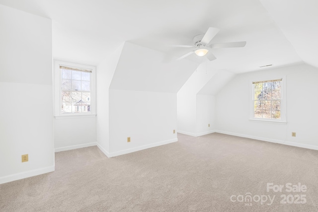 bonus room featuring carpet, ceiling fan, lofted ceiling, and baseboards